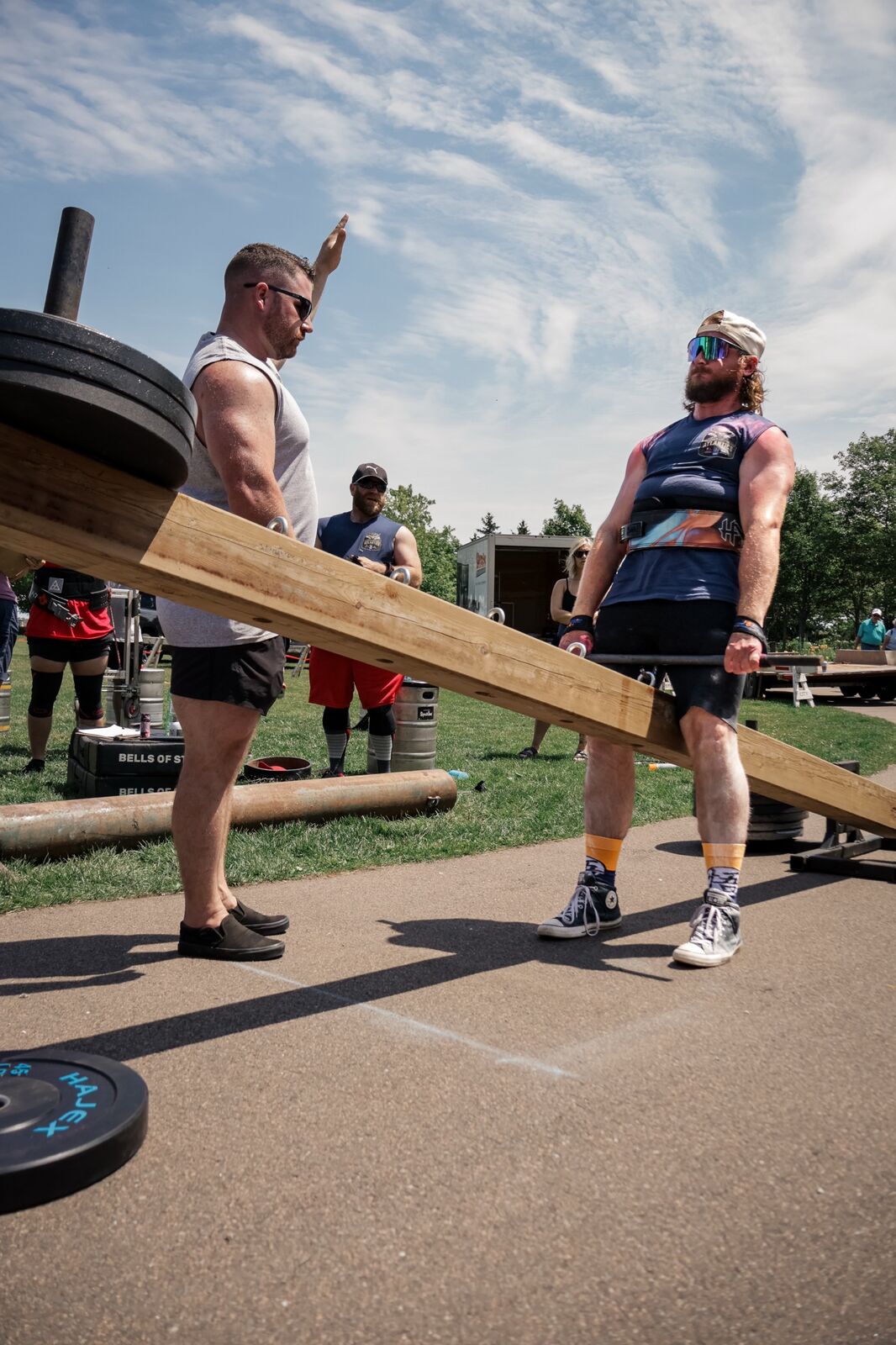 New Scotland Strength client lifting a loaded wooden beam as a judge signals