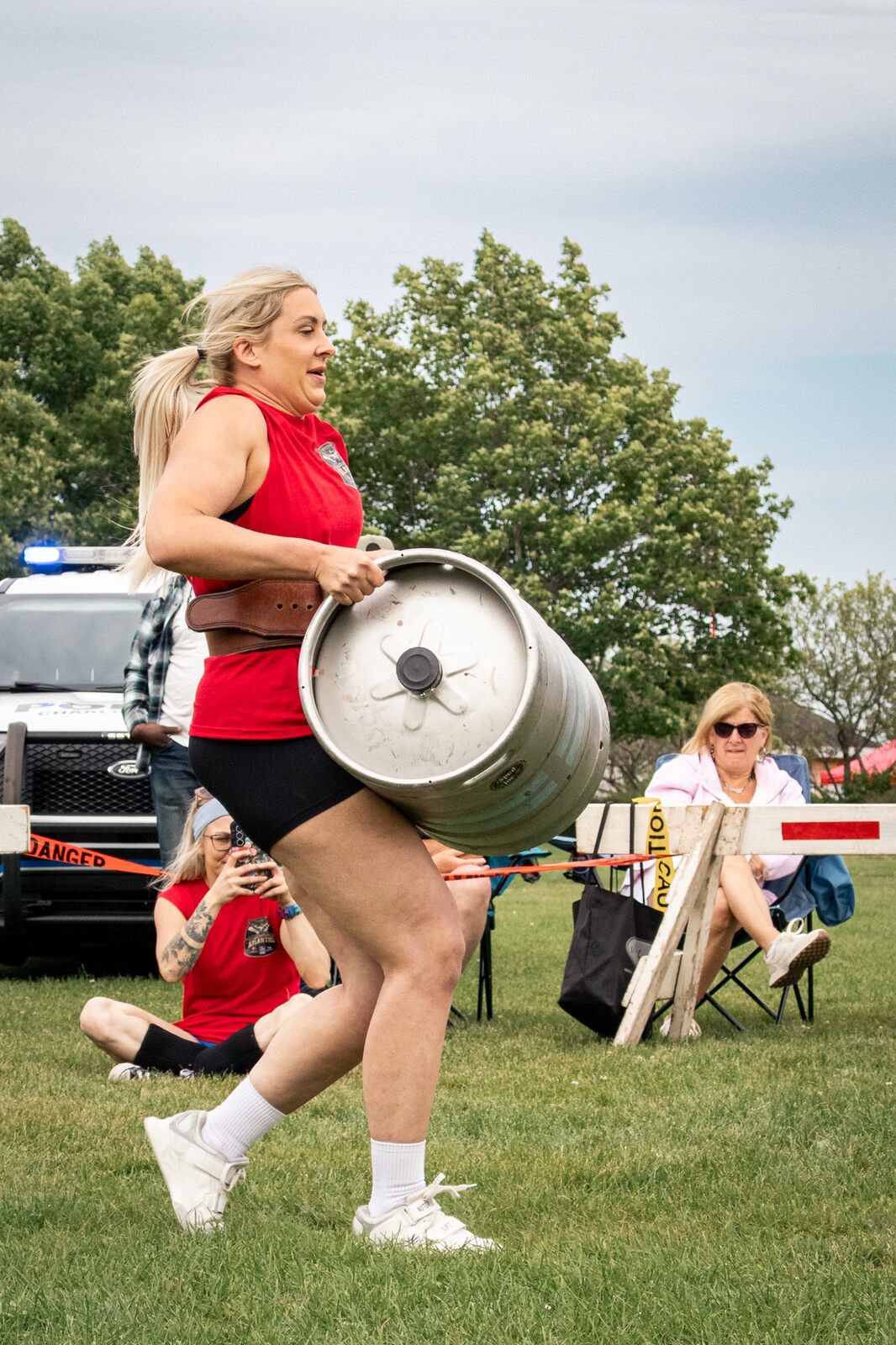 New Scotland Strength client running with a keg at a strongman competition