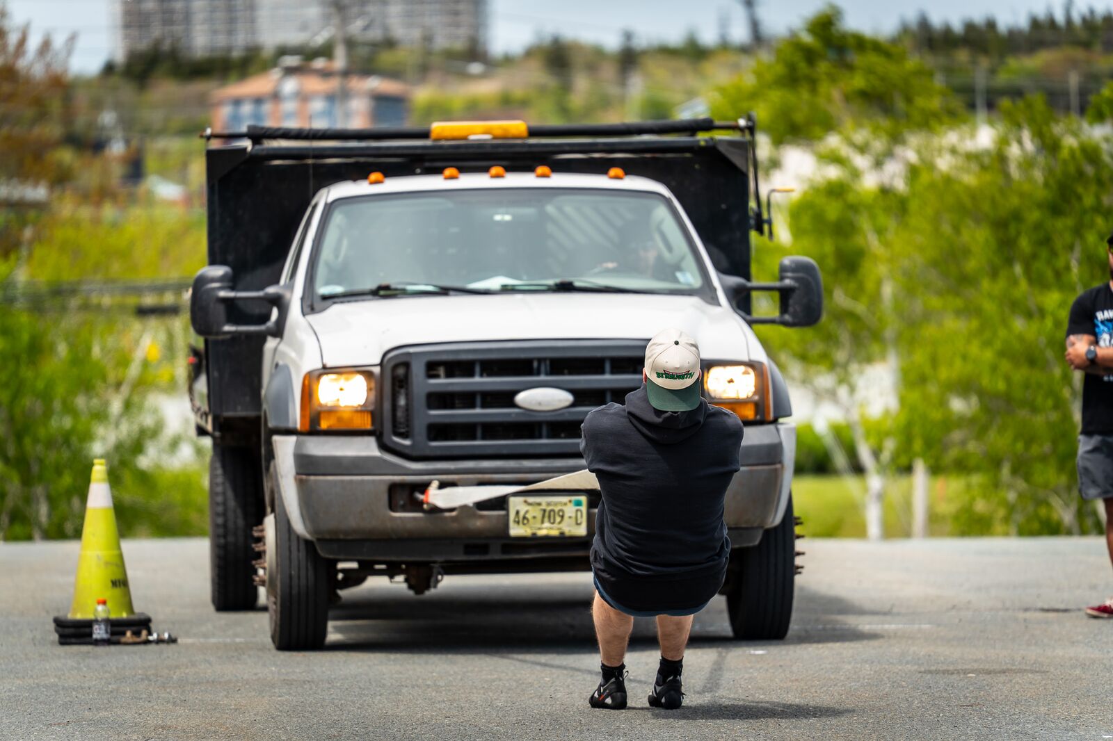Athlete in a New Scotland Strength hat pulling a truck